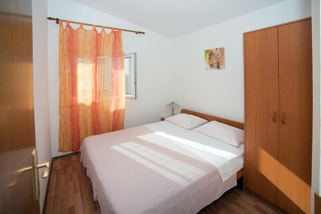 Postel nebo postele na pokoji v ubytování Apartments Drago Kovačić