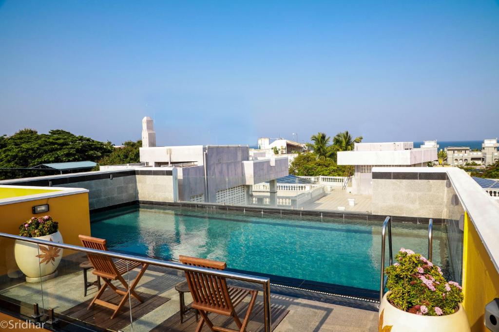 a swimming pool on the balcony of a building at Petit Palais in Pondicherry