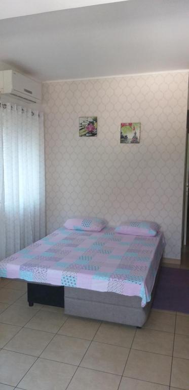 1 dormitorio con 1 cama con edredón morado en Apartment Marko, en Šibenik