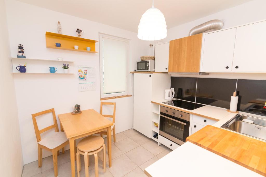 a kitchen with a table and a dining room at Apartament Pomorski in Hel