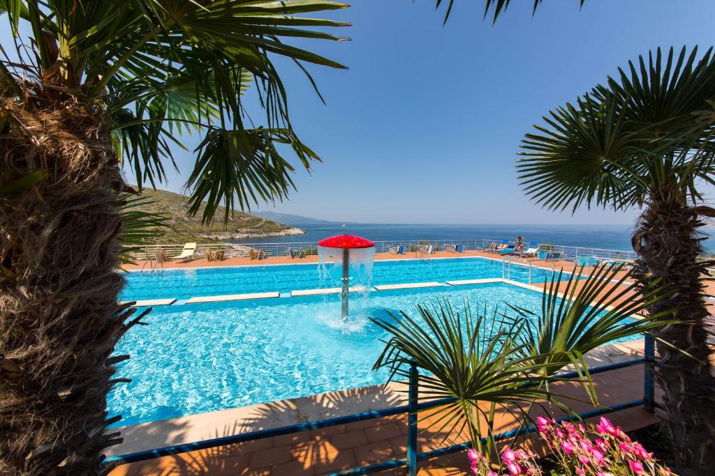 a swimming pool with a view of the ocean at Hotel Bahamas in Sarandë