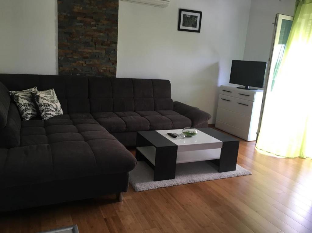 a living room with a couch and a coffee table at New modern apartment in Selce