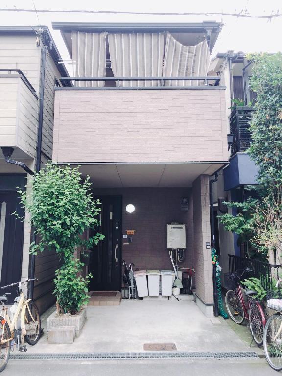 a house with bikes parked outside of it at Ryokoheya Awajikan in Osaka