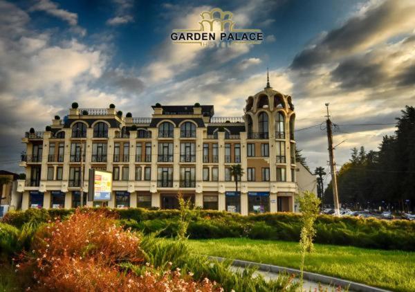 a large building with a sign on top of it at Garden Palace in Zugdidi