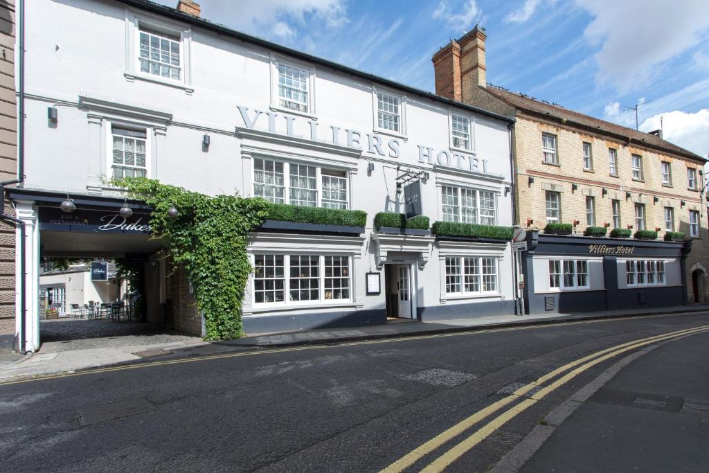 een wit gebouw aan de straatkant bij Villiers Hotel in Buckingham