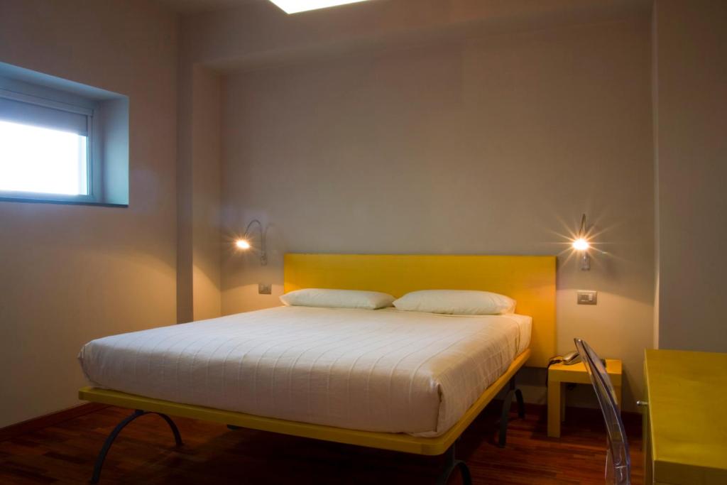 a bedroom with a bed with two pillows on it at San Lorenzo Si Alberga in Camigliatello Silano