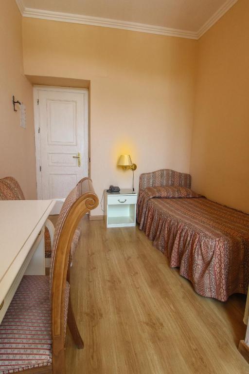 Postel nebo postele na pokoji v ubytování Hotel Moderno