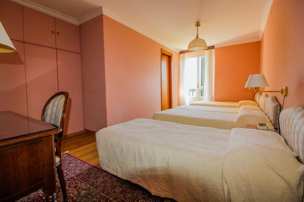 Postel nebo postele na pokoji v ubytování Hotel Moderno