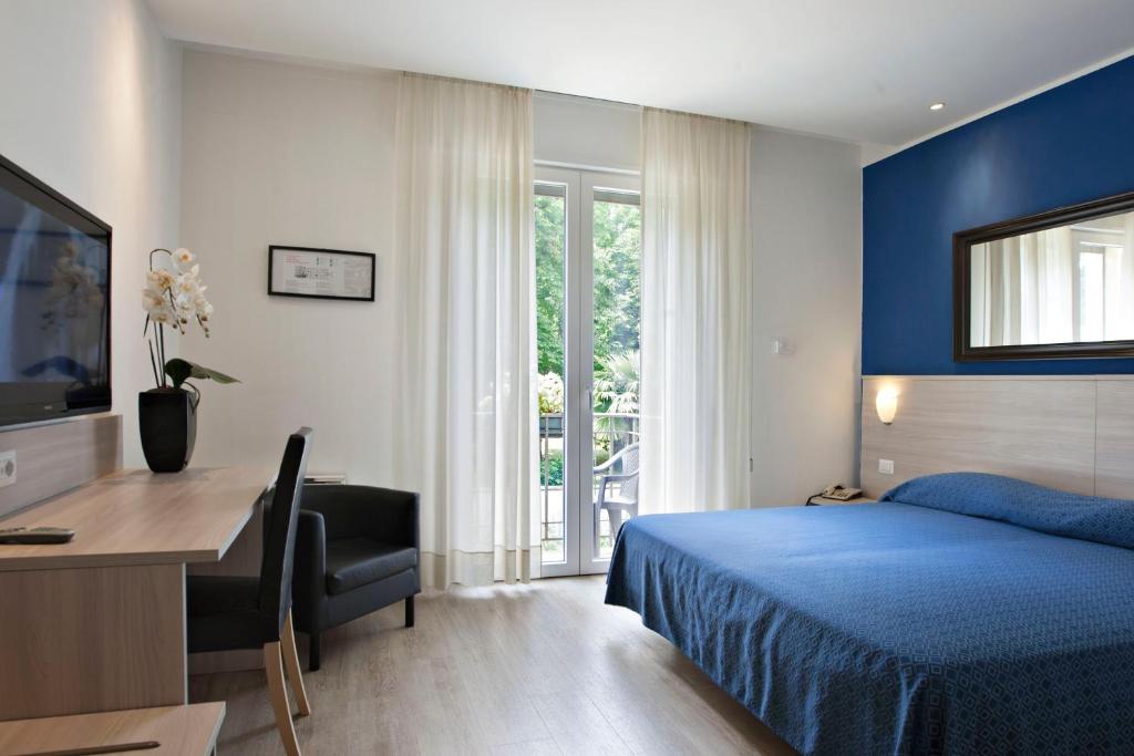 Postel nebo postele na pokoji v ubytování Hotel Garibaldi