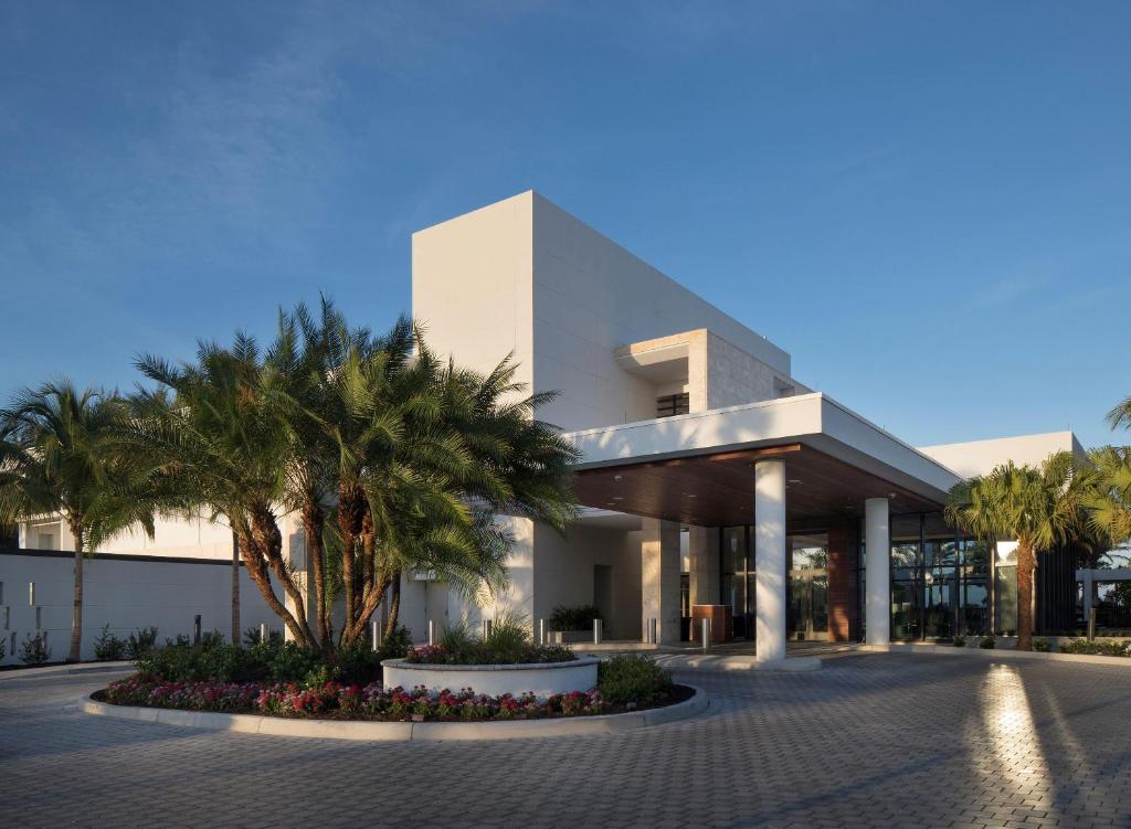 a building with palm trees in front of it at Zota Beach Resort in Longboat Key