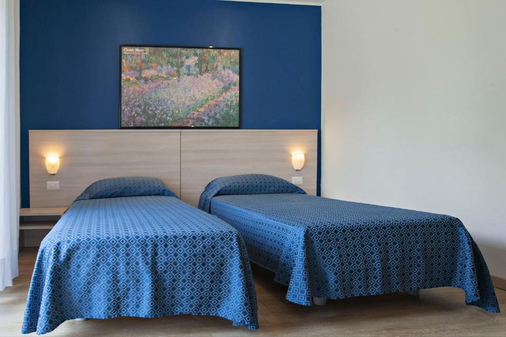 Postel nebo postele na pokoji v ubytování Hotel Garibaldi