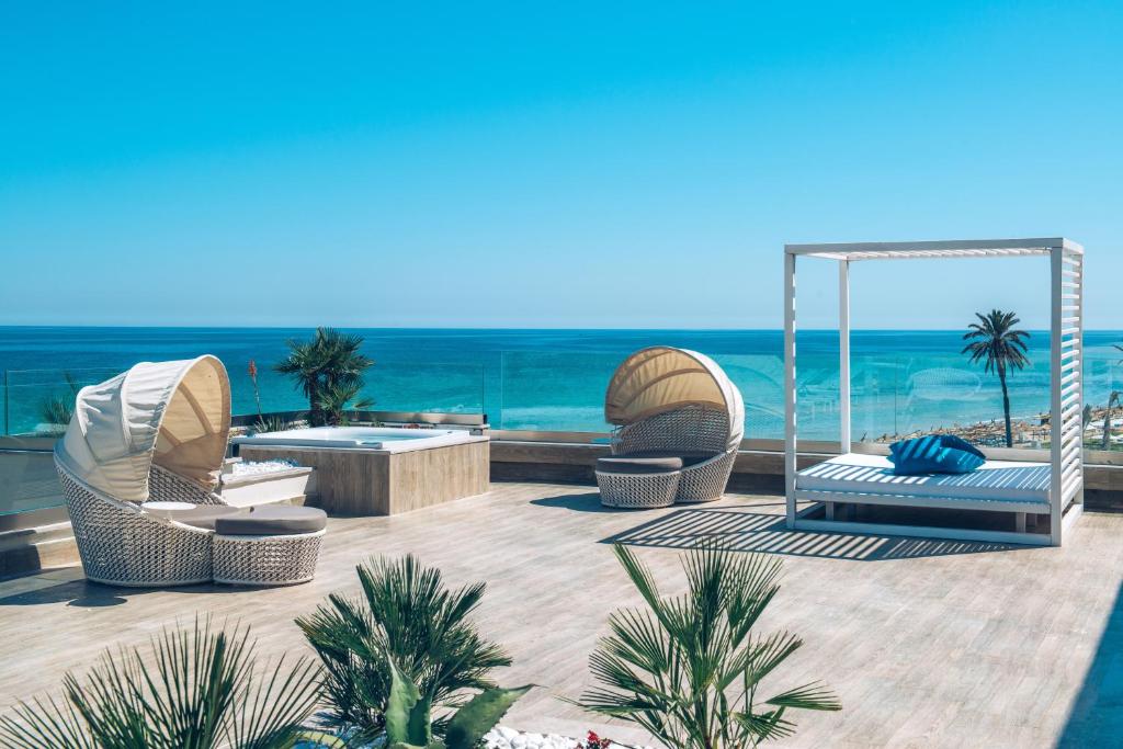 a patio with a view of the ocean at Iberostar Selection Kuriat Palace in Monastir