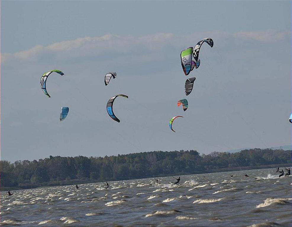 a group of people kite surfing in the water at COCO TENT in Tuoro sul Trasimeno