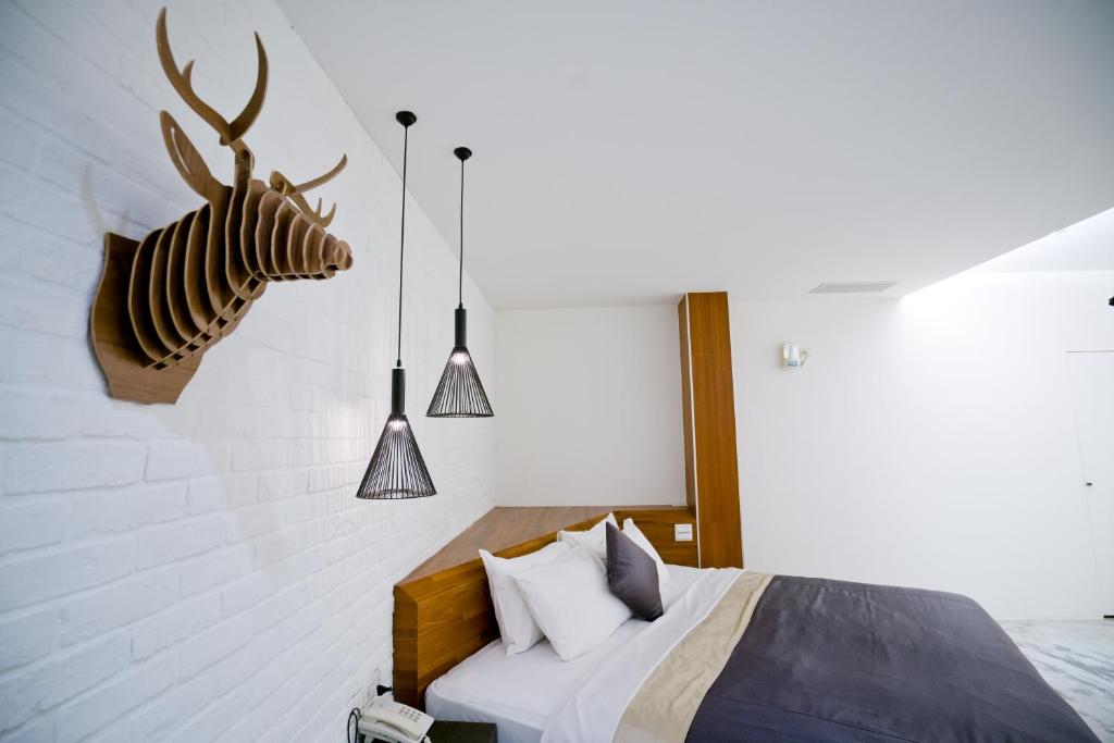 a bedroom with a bed with a deer head on the wall at Hotel Shumei Chiayi in Zhongpu