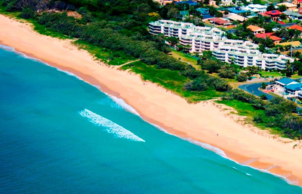 an aerial view of a beach with condos at Surfside On The Beach in Buddina