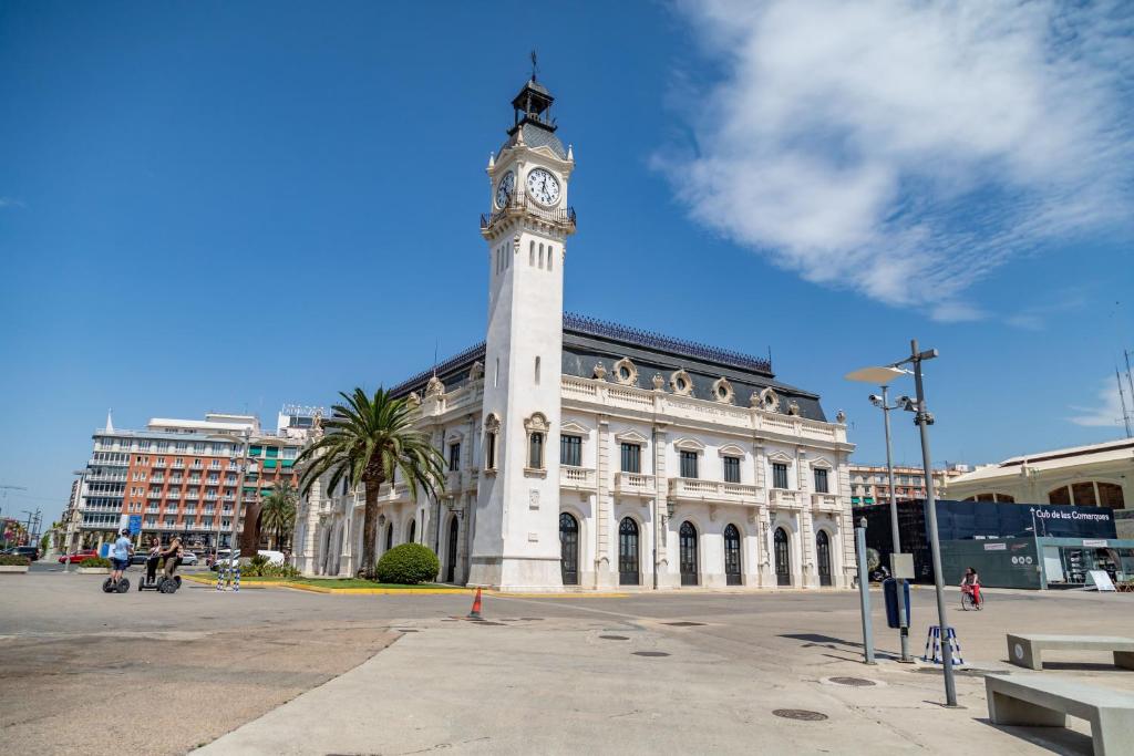 a building with a clock tower on top of it at Travel Habitat Port Valencia. in Valencia