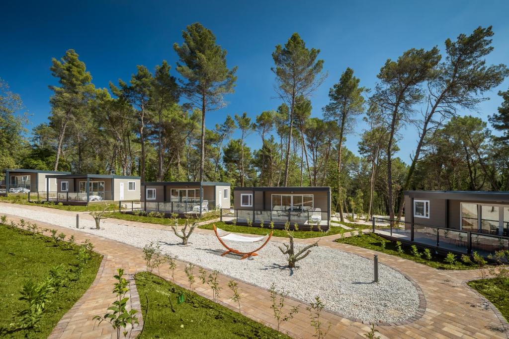 a row of modular homes in the woods at Mobile Homes Camping Santa Marina, Lanterna in Poreč