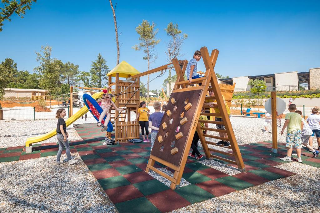 a group of children playing on a playground at Mobile Homes Camping Santa Marina, Lanterna in Poreč