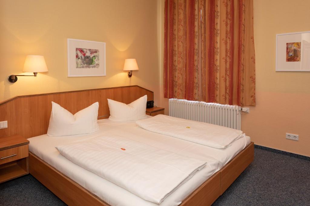 Postel nebo postele na pokoji v ubytování Hotel Europa