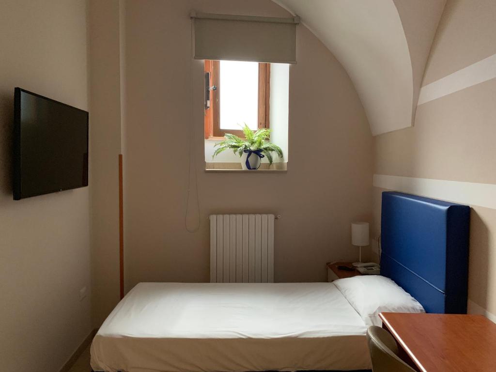 Postel nebo postele na pokoji v ubytování Albergo Ristorante del Cacciatore