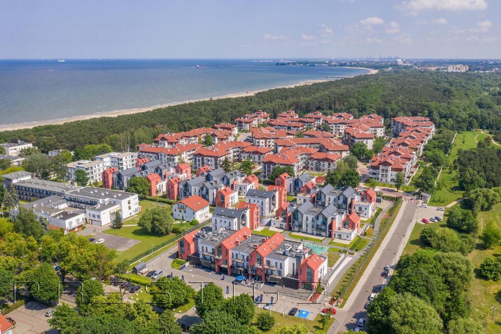 an aerial view of a residential neighborhood next to the water at Prestige Apartments Neptun Park in Gdańsk