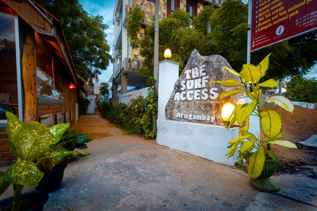 a sign that says the sun access outside a building at The Surf Access Guest House in Arugam Bay