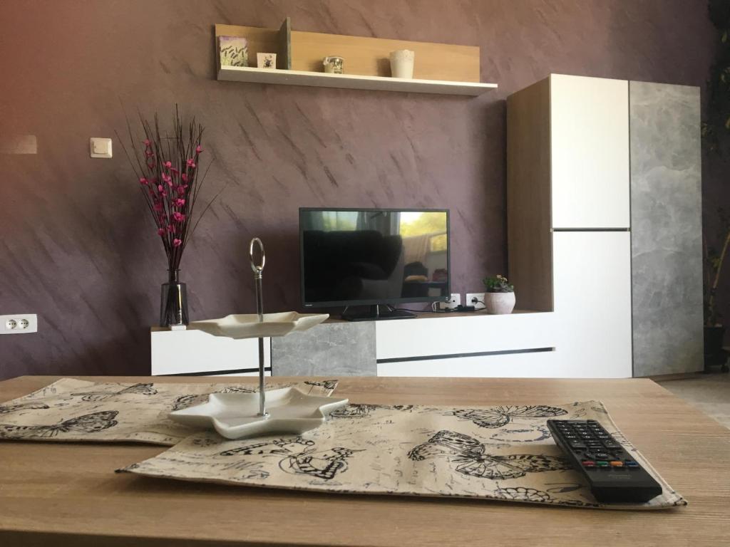 a living room with a remote control on a table at Holly apartman in Umag