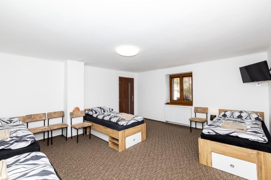 Postel nebo postele na pokoji v ubytování Apartmány Pod Řípem