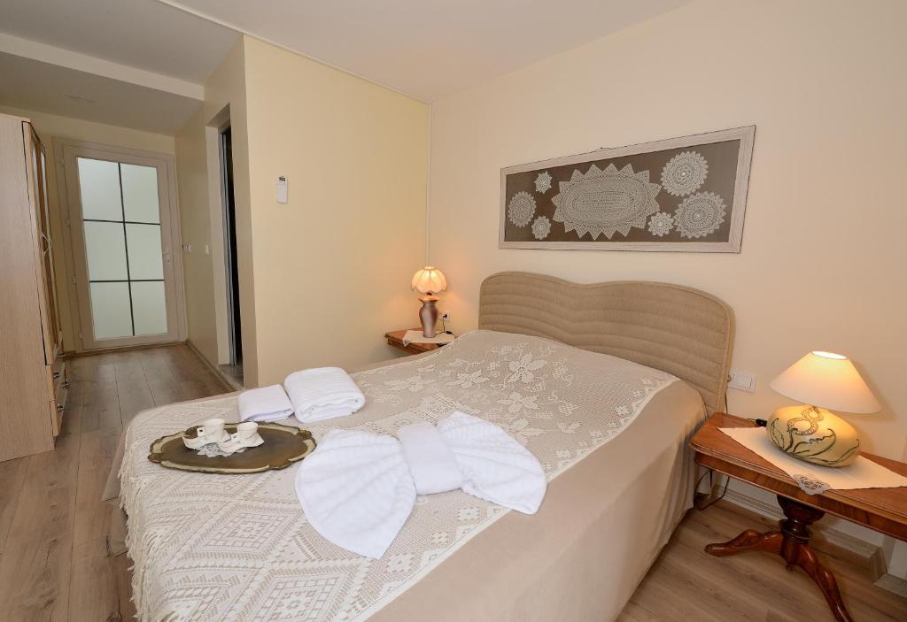 a bedroom with a bed with a tray of food on it at Destina Hotel in Çeşme
