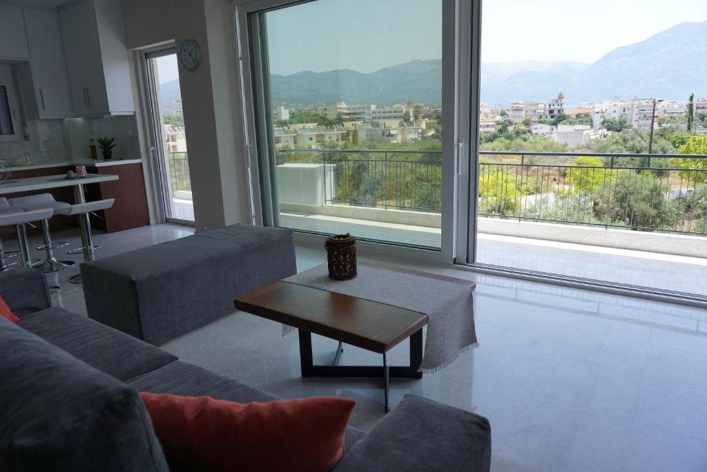 a living room with a couch and a table at AllSeasonsApartment in Kalamata