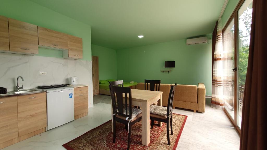 a kitchen and dining room with a table and chairs at Apartment Stanisic in Becici