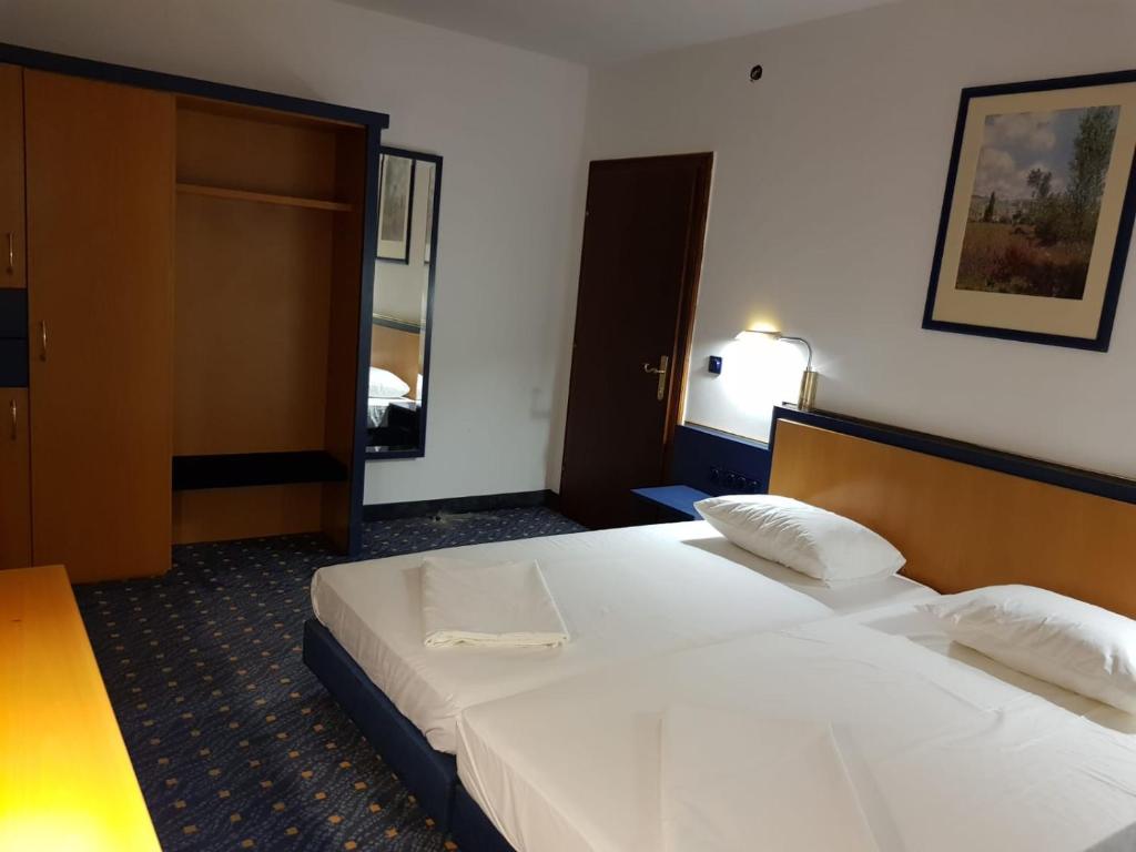 una habitación de hotel con una gran cama blanca. en Portul Dunarii, en Hîrşova