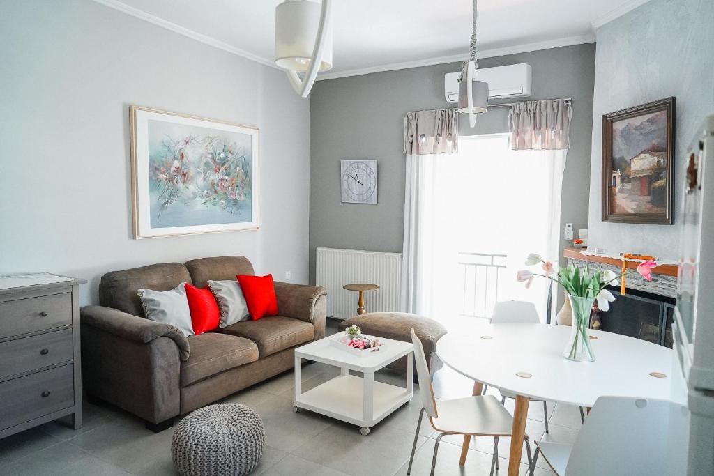 a living room with a couch and a table at Georgia's House in Galatas