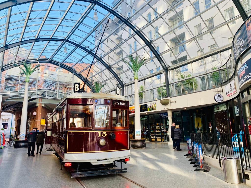 a trolley in a mall with a glass ceiling at Cathedral Junction Apartments in Christchurch