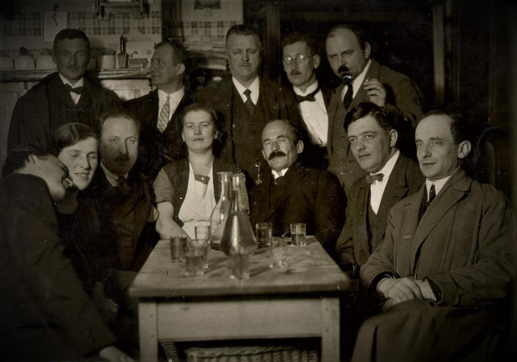 an old photo of a group of people sitting around a table at Kolovrathome in Ljubljana