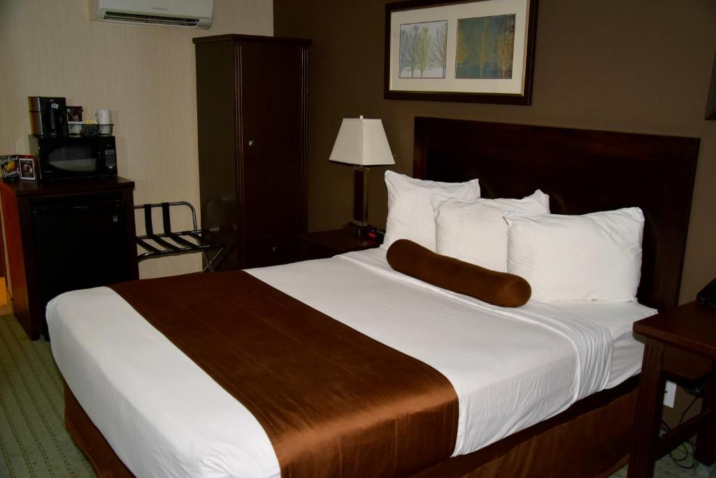 a hotel room with two beds and two lamps at Coast Lethbridge Hotel & Conference Centre in Lethbridge