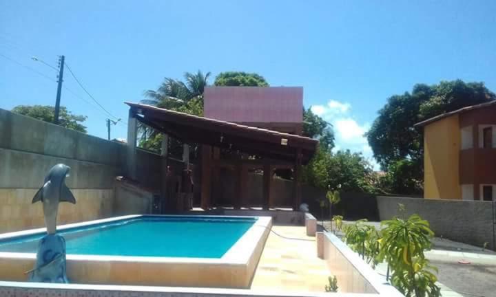 a swimming pool in the backyard of a house at Residencial Jardins in Itamaracá