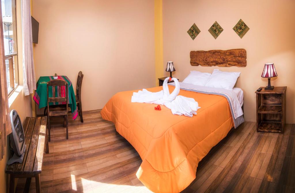 Postel nebo postele na pokoji v ubytování Le Foyer Colca