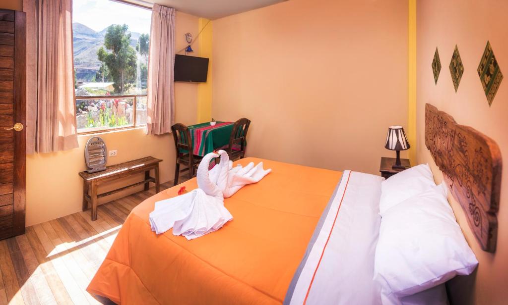 Postel nebo postele na pokoji v ubytování Le Foyer Colca