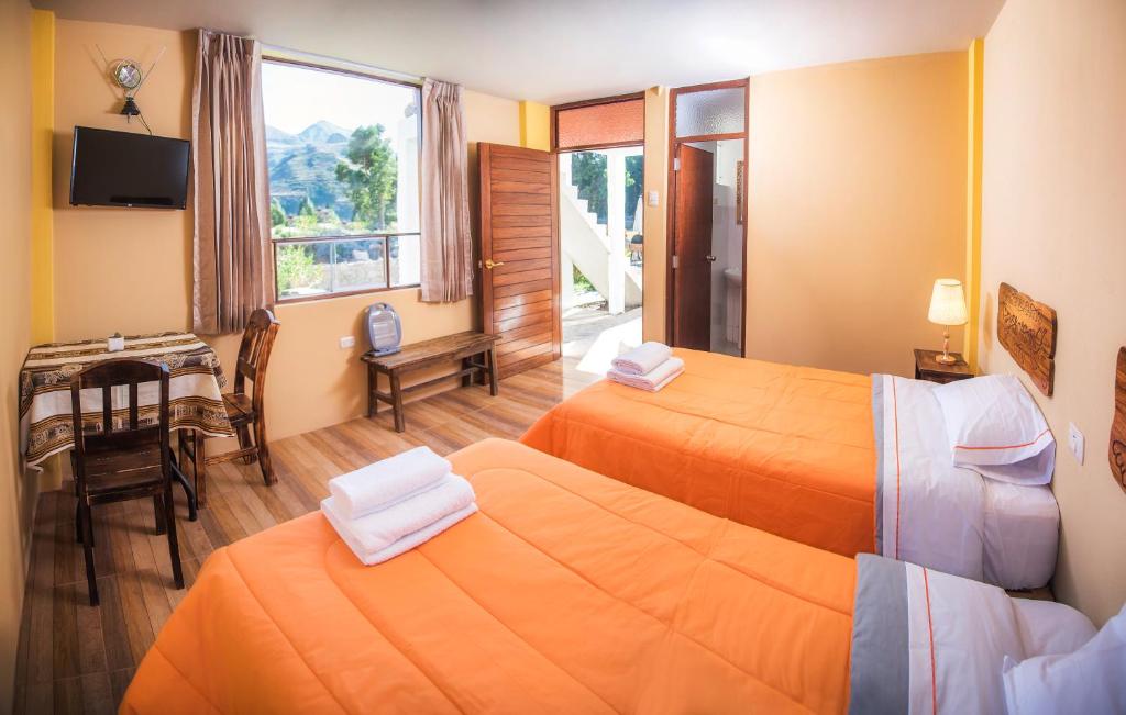 Postel nebo postele na pokoji v ubytování Le Foyer Colca