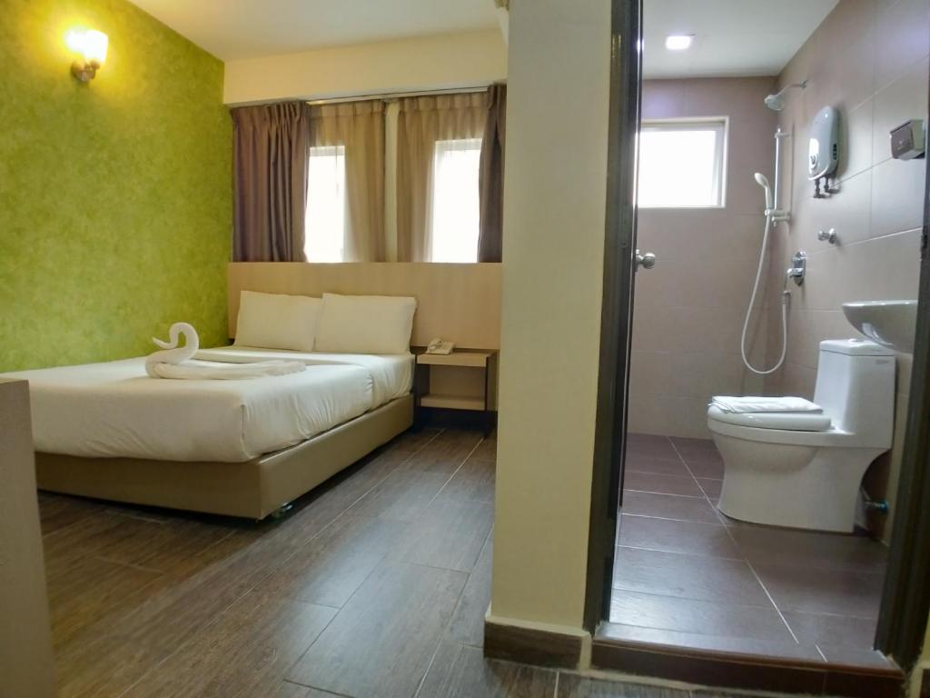 A bedroom photographed beside its compact en-suite bathroom.