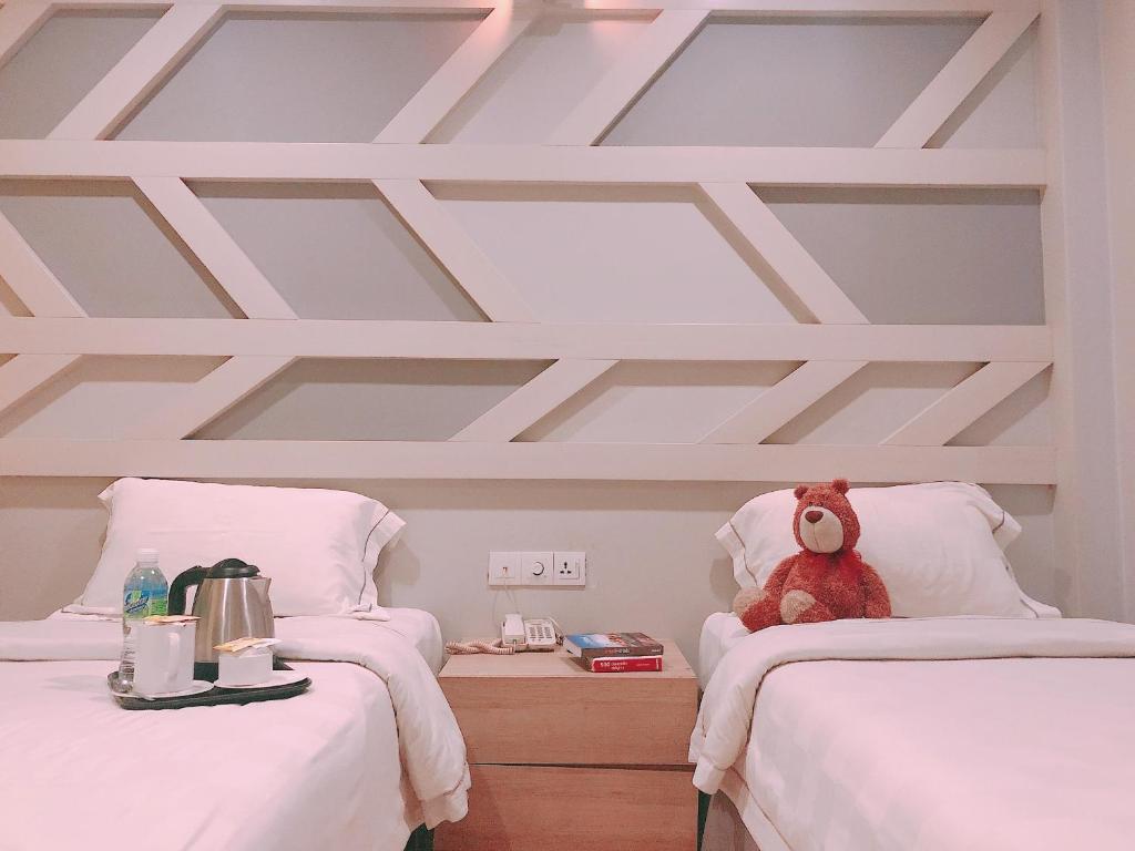 Postel nebo postele na pokoji v ubytování Sunshine Inn