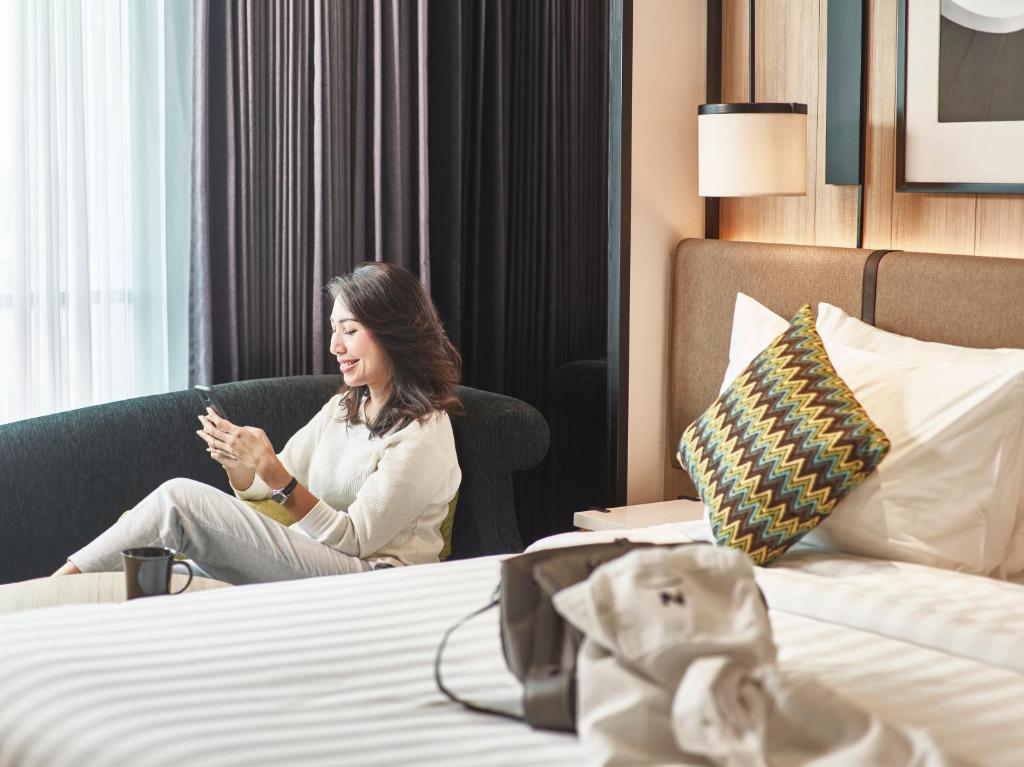 Postel nebo postele na pokoji v ubytování Novotel Karawang