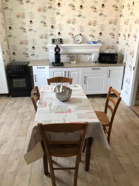 a kitchen with a table and chairs in a room at Chez Nono et Soso in Eurville