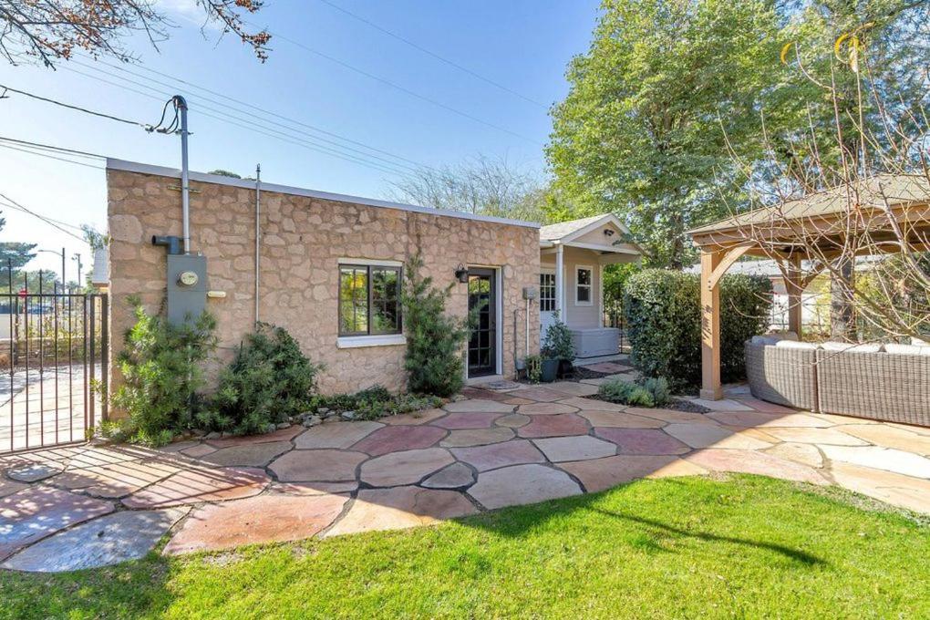 a brick house with a gate and a yard at Best Little Guesthouse in Melrose! New Listing! in Phoenix