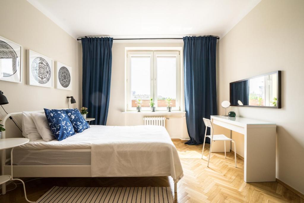 a small bedroom with a bed and a desk at ★Bright, spacious apartment|Palace of Culture view★ in Warsaw