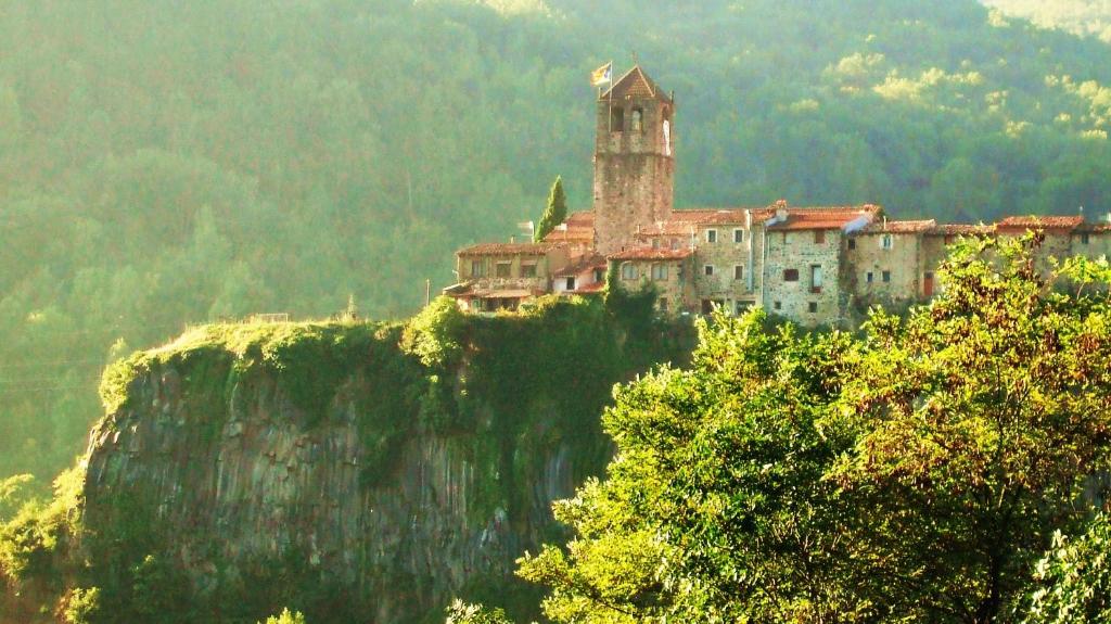 a castle on top of a mountain on a cliff at Hostal Mont-Rock in Montagut