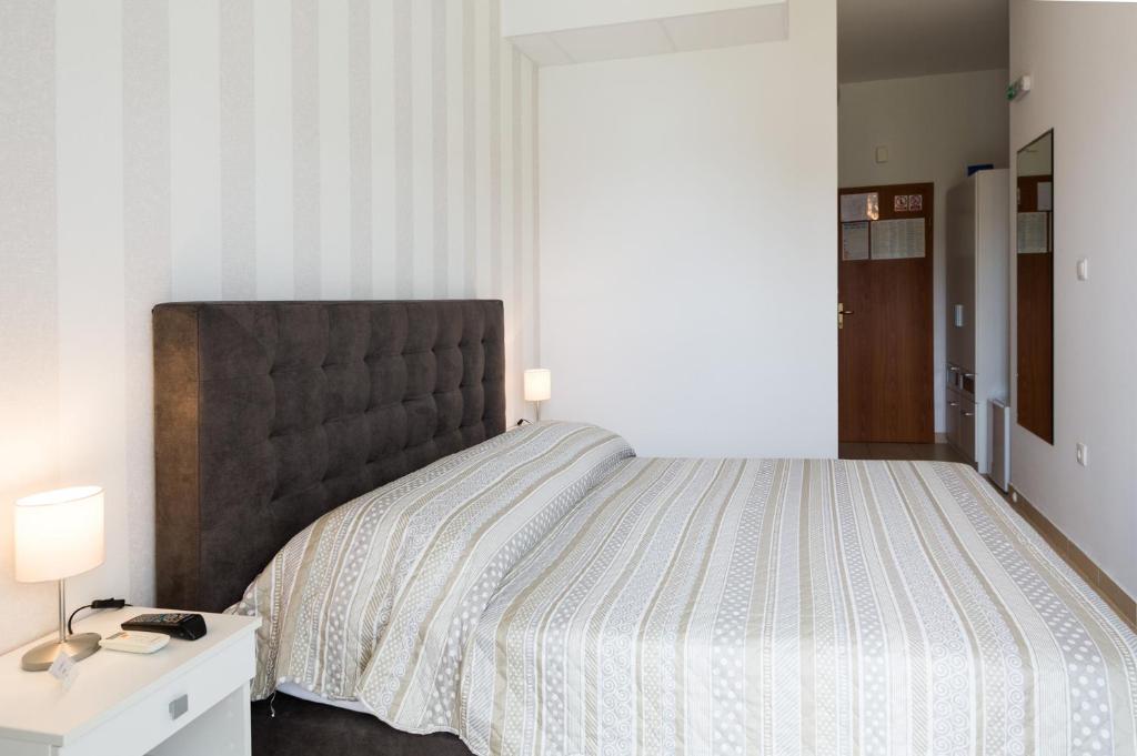 Posteľ alebo postele v izbe v ubytovaní Rooms & Apartments Bruno
