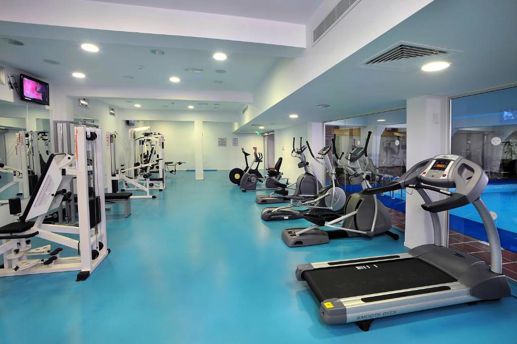a gym with a row of treadms and machines at Nestor Hotel in Ayia Napa