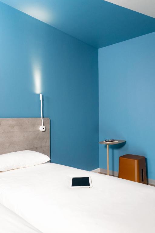 Postel nebo postele na pokoji v ubytování Ibis Budget Aubenas